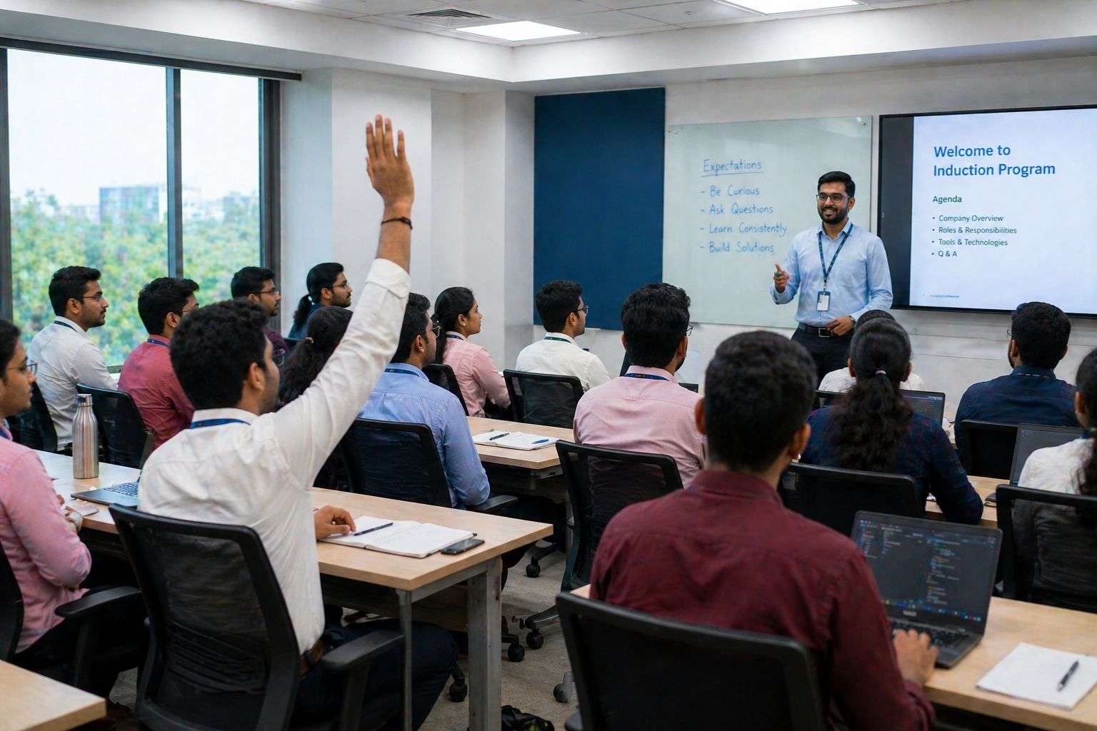IT company fresher training period India — onboarding batch classroom session